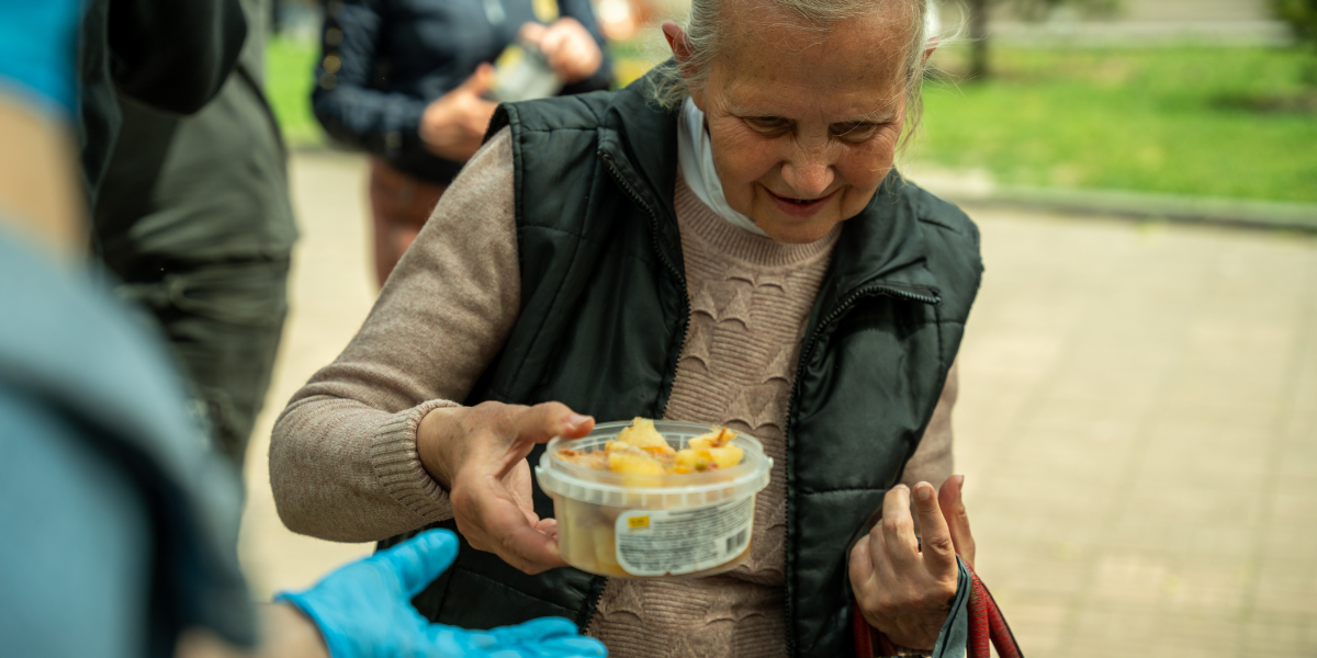 Woman in Ukraine receiving food