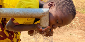 Child drinking from Well